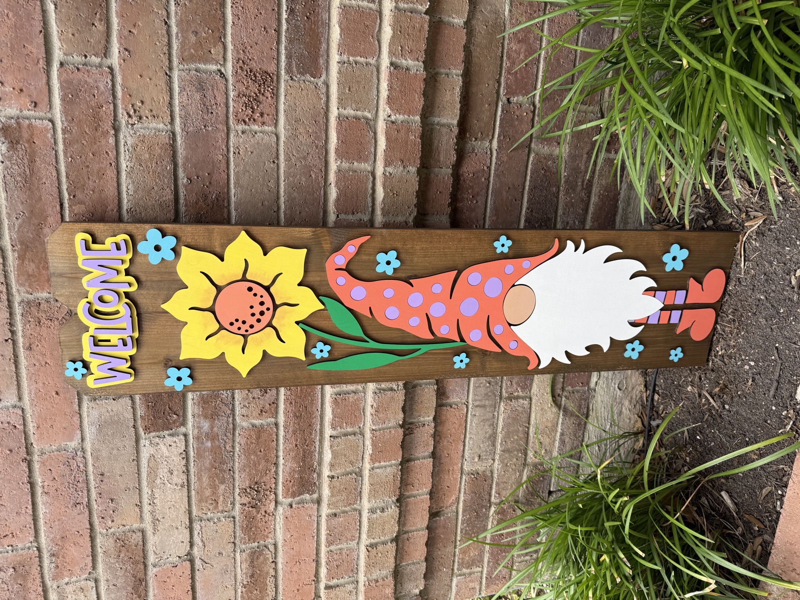 Spring gnome welcome porch sign with sunflower and blue flowers on stained cedar