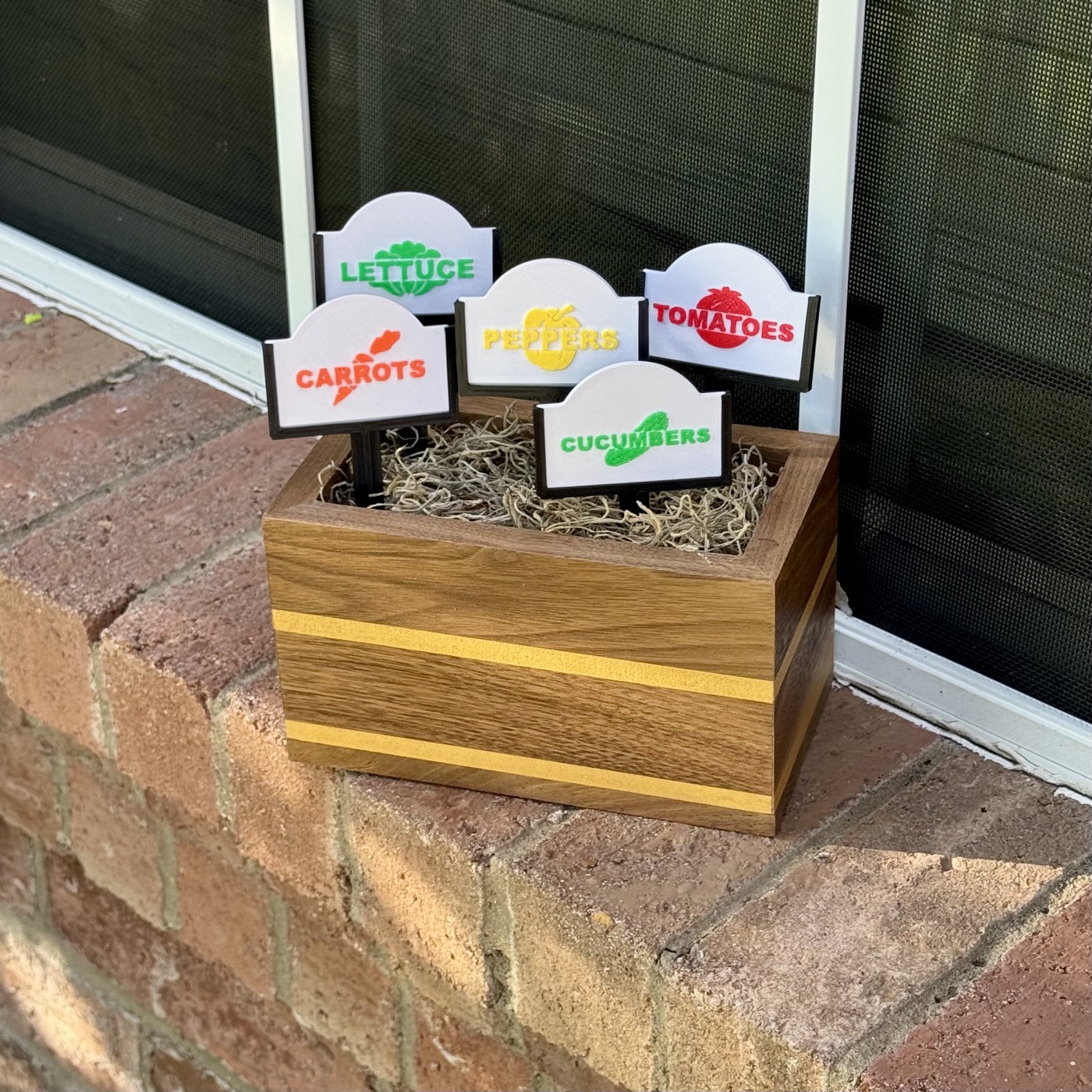 Walnut herb garden display box with colorful laser-cut vegetable marker signs